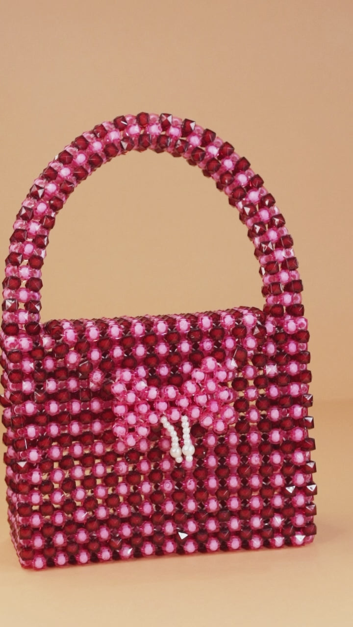 Glossy Pink Beaded Handbag with Charm
